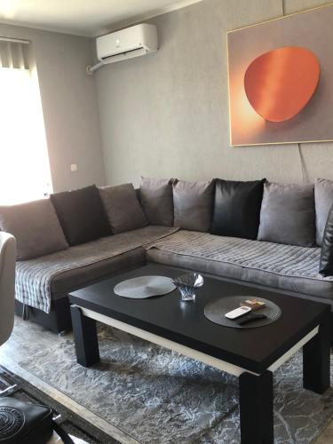 a living room with a couch and a coffee table at Centre apartment in Prilep