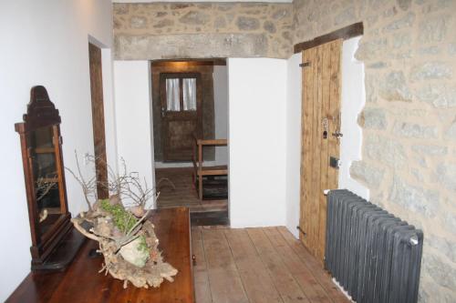 a living room with a stone wall and a door at Ca' Morano in Pavullo nel Frignano