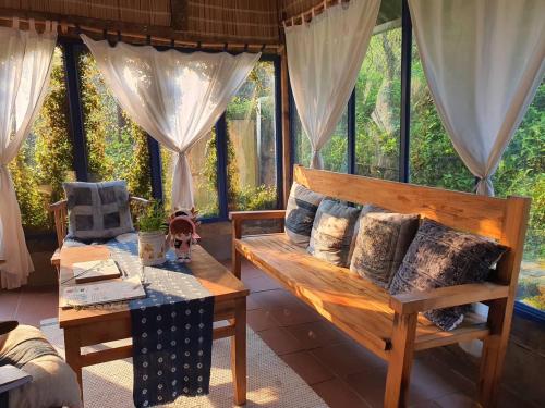 a room with a couch and a table with pillows at H’nee House Ta Van in Sa Pa