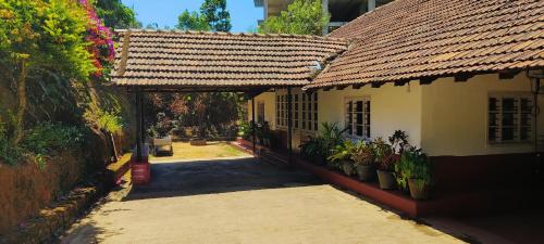 an entrance to a house with a tile roof at Coorg Daffodil Guesthouse in Madikeri