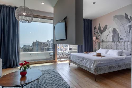 a bedroom with a bed and a large window at City Apartments 2 in Budva