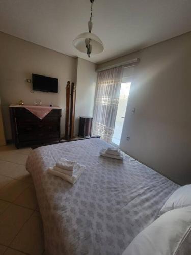 - une chambre avec un grand lit et 2 serviettes dans l'établissement Konstanz apartment, à Markopoulon
