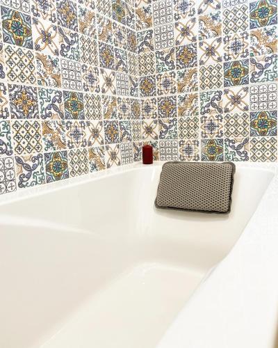 a bathroom with tiles on the wall and a bench at Sara&Sera in Umag