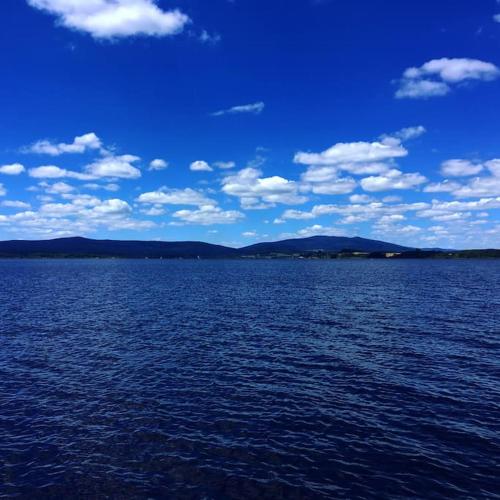 a large body of water with a blue sky and clouds at Apartmán s terasou a výhledem na jezero Lipno in Kovářov