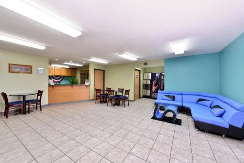 a room filled with furniture and a blue floor at Americas Best Value Inn - Seymour in Seymour
