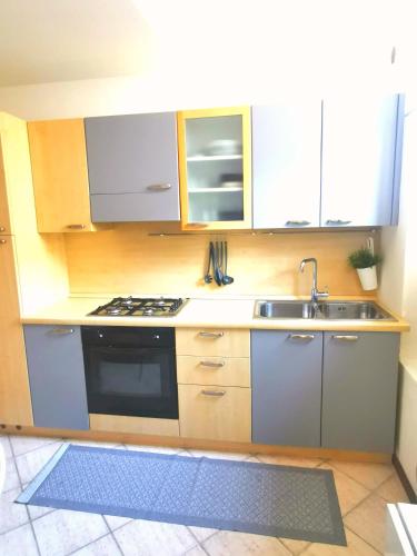 a kitchen with a sink and a stove top oven at Old Town Apartment with Terrace - Live Love Lake in Peschiera del Garda