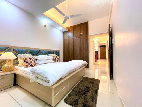 um quarto com uma cama grande e um tecto em Airport Bliss Apartment+Balcony & Netflix + Prime em Jaipur