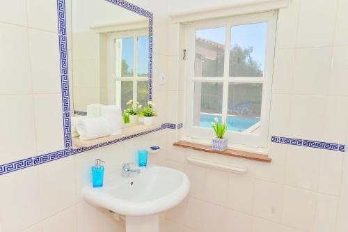 a white bathroom with a sink and a mirror at VILLA MONTE PARDAL w/ Heated Pool in Natural Park in Moncarapacho