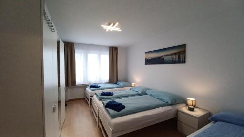 a bedroom with two beds and a window at Apartment Bünda in Davos
