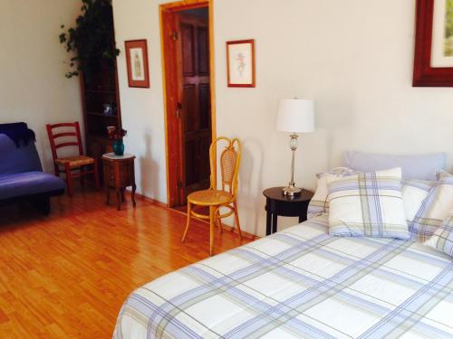 a bedroom with a bed and a table and chairs at Maria Del Alma House in Mexico City