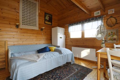 a bedroom with a bed in a wooden room at Cozy cottage with 10 beds near Landvetter in Landvetter