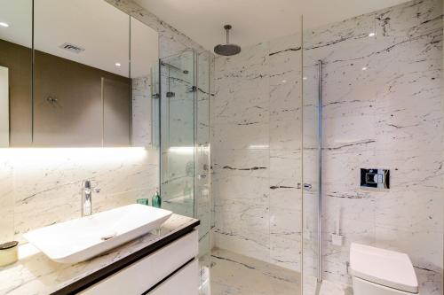 a bathroom with a sink and a glass shower at Chic and Scenic Studio Flat in Sisli in Istanbul