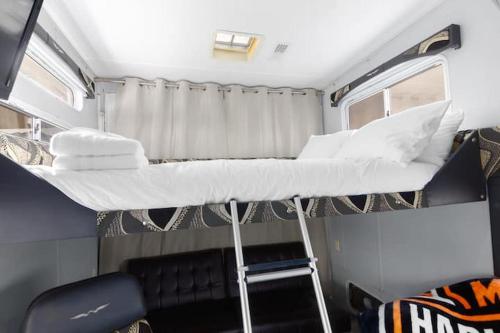 a bedroom with a bunk bed in an rv at Harley Davidson Ranch Glampling With Kids Play Zone in Ramona