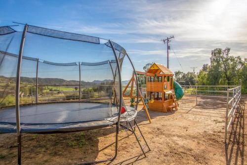 a playground with a trampoline and a house at Harley Davidson Ranch Glampling With Kids Play Zone in Ramona