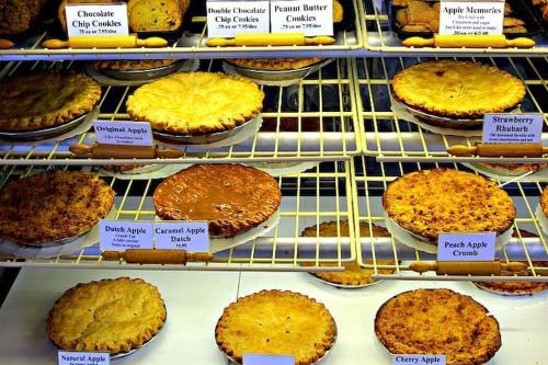 a display case in a bakery with cakes and pies at Harley Davidson Ranch Glampling With Kids Play Zone in Ramona