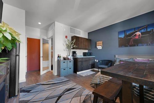 a kitchen and living room with blue walls and a table at Beacon Hotel in Beacon