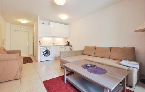 a living room with a couch and a table at Awesome Apartment In Vallauris With Kitchenette in Vallauris