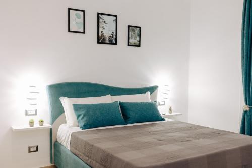 a bedroom with a bed with blue and white at Maison Lorelle - De Vivo Realty Sorrento in Sorrento