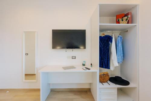 una scrivania bianca in una camera bianca con TV di Maison Lorelle Sorrento a Sorrento