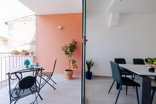a dining room with a table and chairs at Maison Lorelle - De Vivo Realty Sorrento in Sorrento