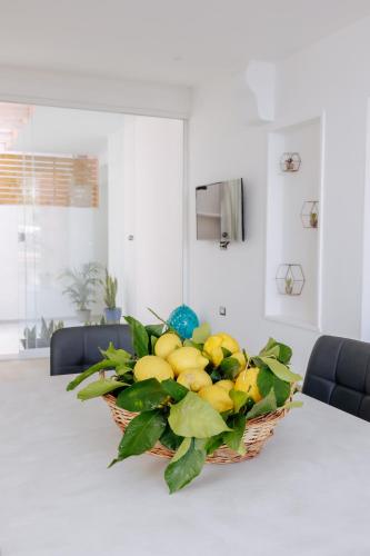a basket of lemons sitting on a table at Maison Lorelle - De Vivo Realty Sorrento in Sorrento
