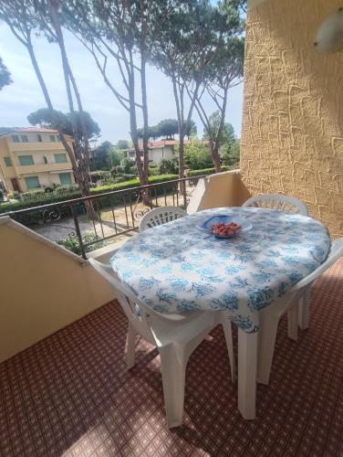 a table with a blue and white table cloth on a balcony at L'Orchidea_Holiday in Camaiore