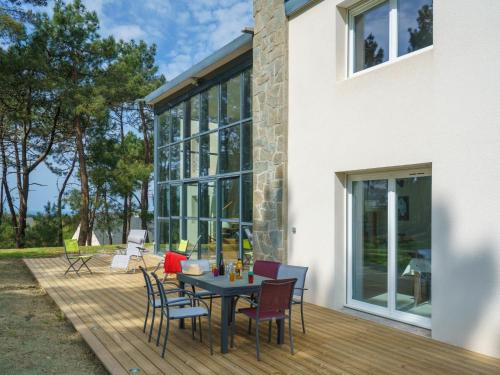 a patio with a table and chairs on a deck at Holiday Home du bois du Kador by Interhome in Morgat