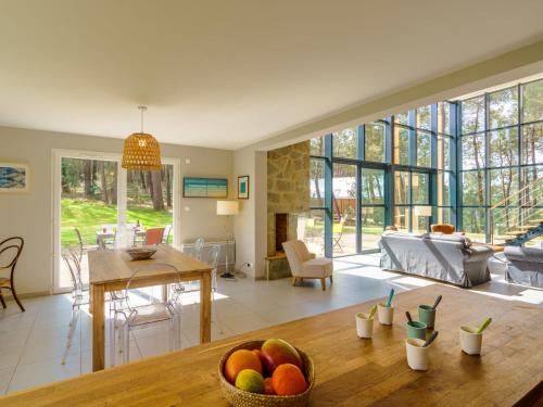 a living room with a table with a bowl of fruit on it at Holiday Home Maison du bois du Kador by Interhome in Morgat