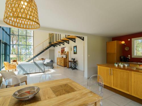 a kitchen and living room with a dining room at Holiday Home Maison du bois du Kador by Interhome in Morgat