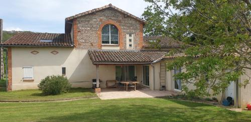 a house with a table in the front yard at Chez Cathie à Muret in Muret