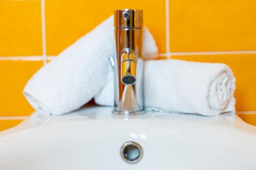 a bathroom sink with a faucet and towels on it at Boccioleto Resort - Place of Charme in Montaione