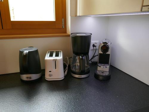 three appliances sitting on a counter in a kitchen at Apartment Chalet Bienli Mitte by Interhome in Grindelwald