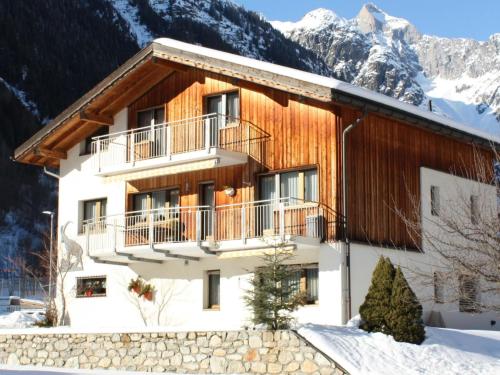 a house in the mountains with snow at Apartment Saphir by Interhome in Fieschertal