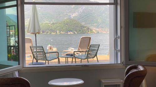 a view of a table and chairs from a window at Hotel Villa Aurora in Lezzeno