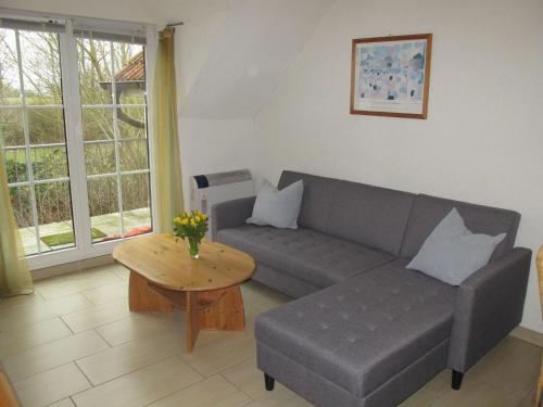a living room with a couch and a table at Apartment Gollwitzer Park - Insel Poel-2 by Interhome in Gollwitz