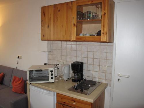 a kitchen with a counter with a toaster and a microwave at Apartment Gollwitzer Park - Insel Poel-5 by Interhome in Gollwitz