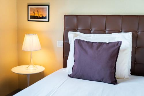 a bedroom with a bed with a pillow and a lamp at Boccioleto Resort - Place of Charme in Montaione