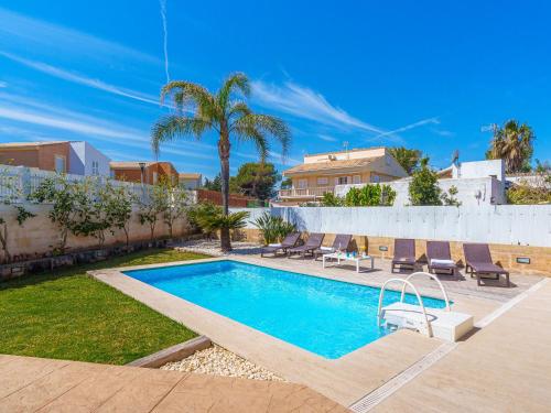 a swimming pool in a yard with lounge chairs at Villa Son Jil by Interhome in Alcudia