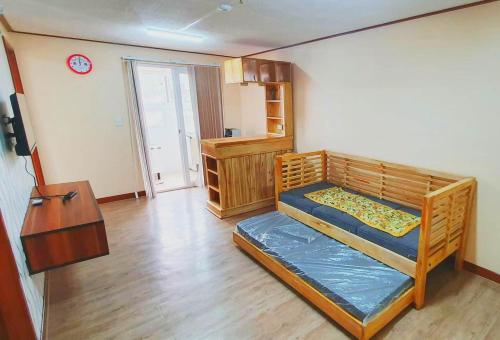 a room with two bunk beds and a table at Zenmist Properties- 2 Bedroom Deluxe in Baguio