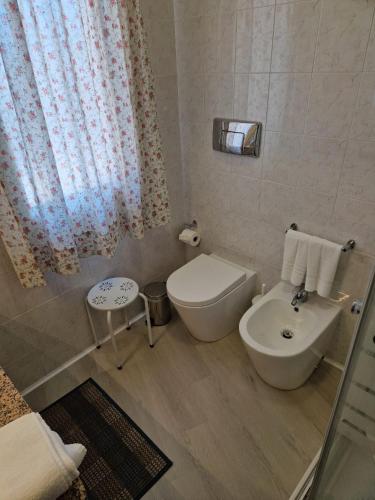 a small bathroom with a toilet and a sink at Ca'Mea in Villasimius