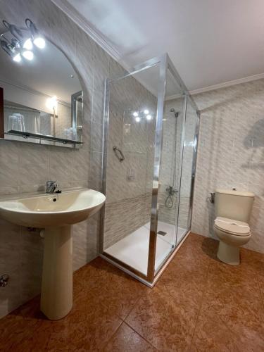 a bathroom with a shower and a sink and a toilet at Luarca Zabala in Luarca