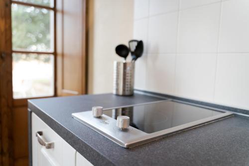 a kitchen counter with a sink and two cups on it at Boccioleto Resort - Place of Charme in Montaione