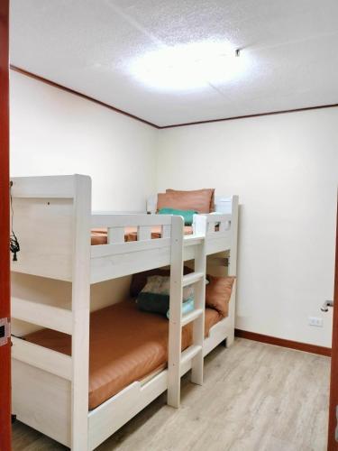 a bedroom with two bunk beds in a room at Zenmist Properties- 2 Bedroom Deluxe in Baguio