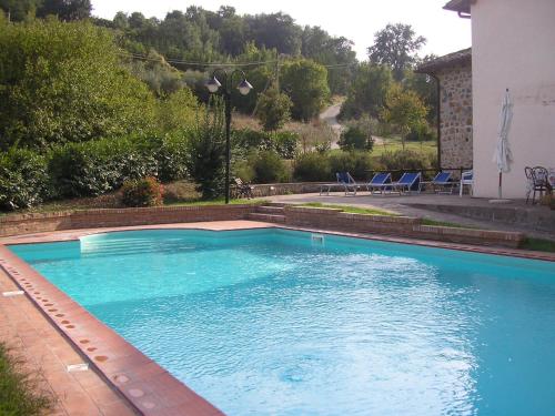 a large blue swimming pool in front of a house at Villa Acquafredda in Orvieto