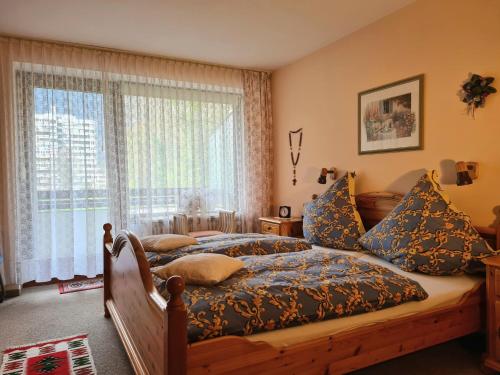 a bedroom with a bed and a large window at Ferienwohnung Eckl in Bad Reichenhall