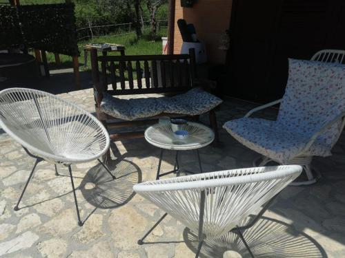 a group of chairs and a table and a bench at Casa degli Ulivi in Tolentino