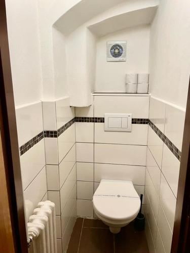 a small white bathroom with a toilet and towels at Chata Anton Günther in Boží Dar