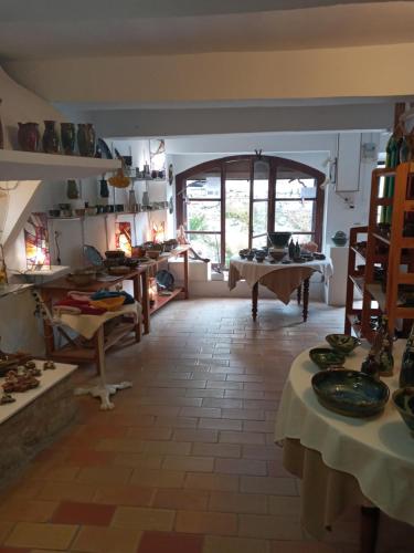 a room with tables and chairs in a room at appartement chez l'artiste in Minerve