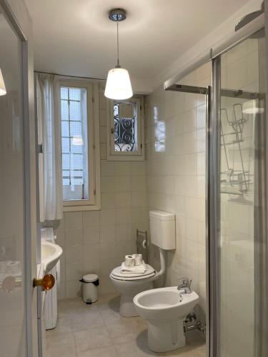 a bathroom with a toilet and a sink and a shower at Ca' Frezzeria in Venice