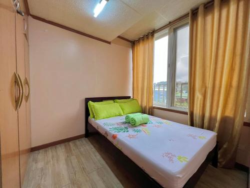 - une petite chambre avec un lit et une fenêtre dans l'établissement Zenmist Properties- 2 Bedroom Economy, à Baguio